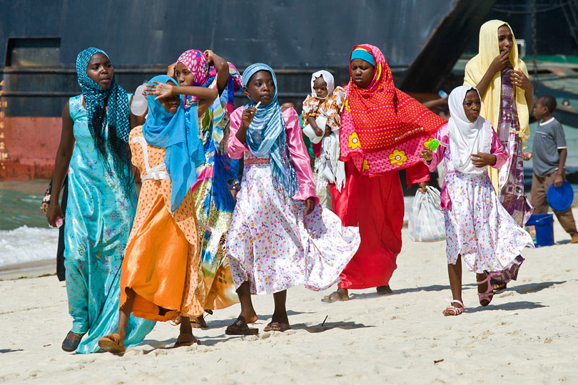 Women wearing traditional dresses &lt;p&gt;on the beach in Stone Town
